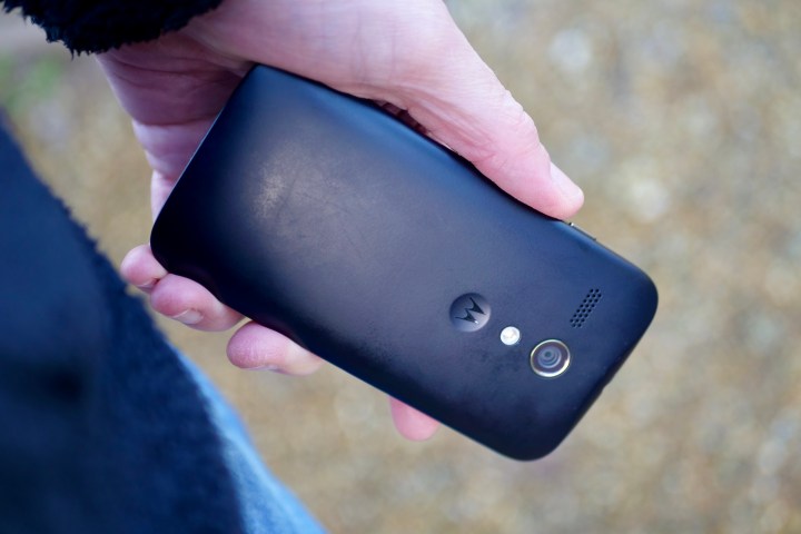 A person holding the Motorola Moto G, showing the back panel.