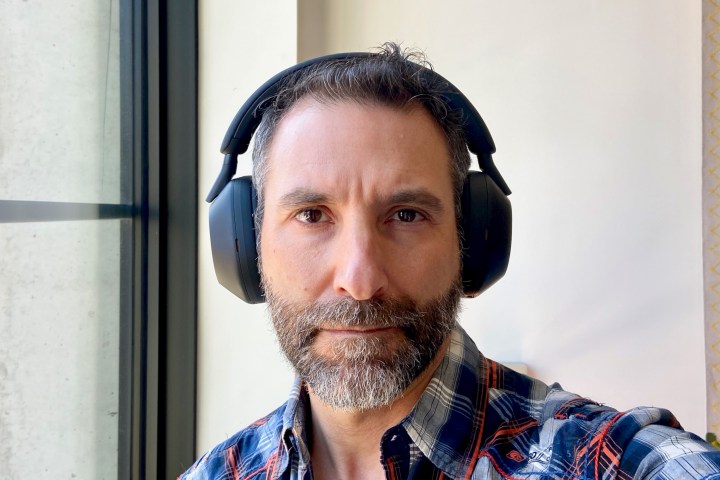 Front view of man wearing Sony WH-1000XM5 wireless headphones.