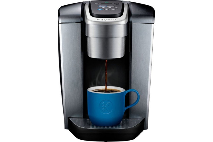 The Keurig K-Elite Coffee Maker dispenses coffee into a blue ceramic mug.
