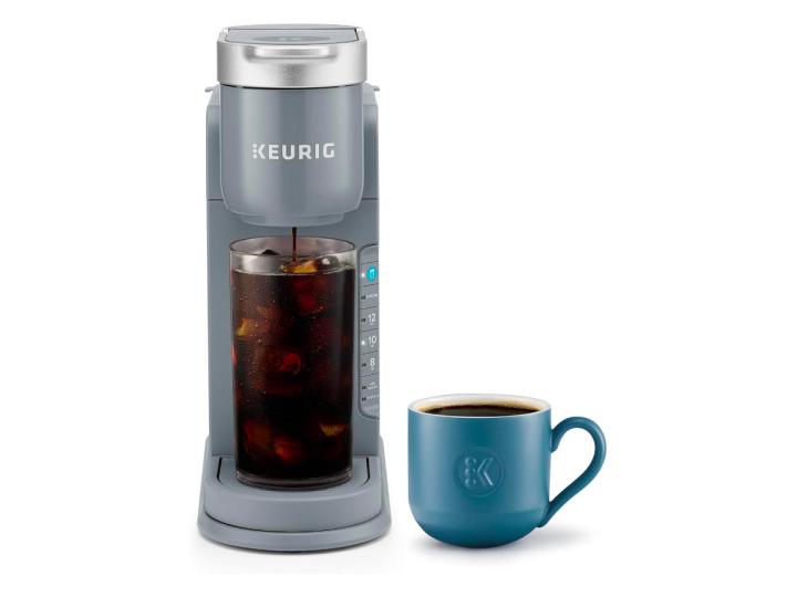 The Keurig K-Iced coffee maker alongside a mug against a white background.