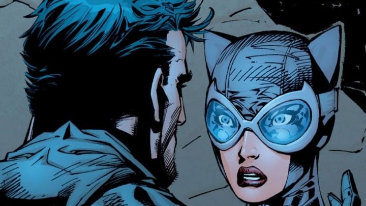 Batman takes off his mask before a shocked Catwoman in a comic book rendering.