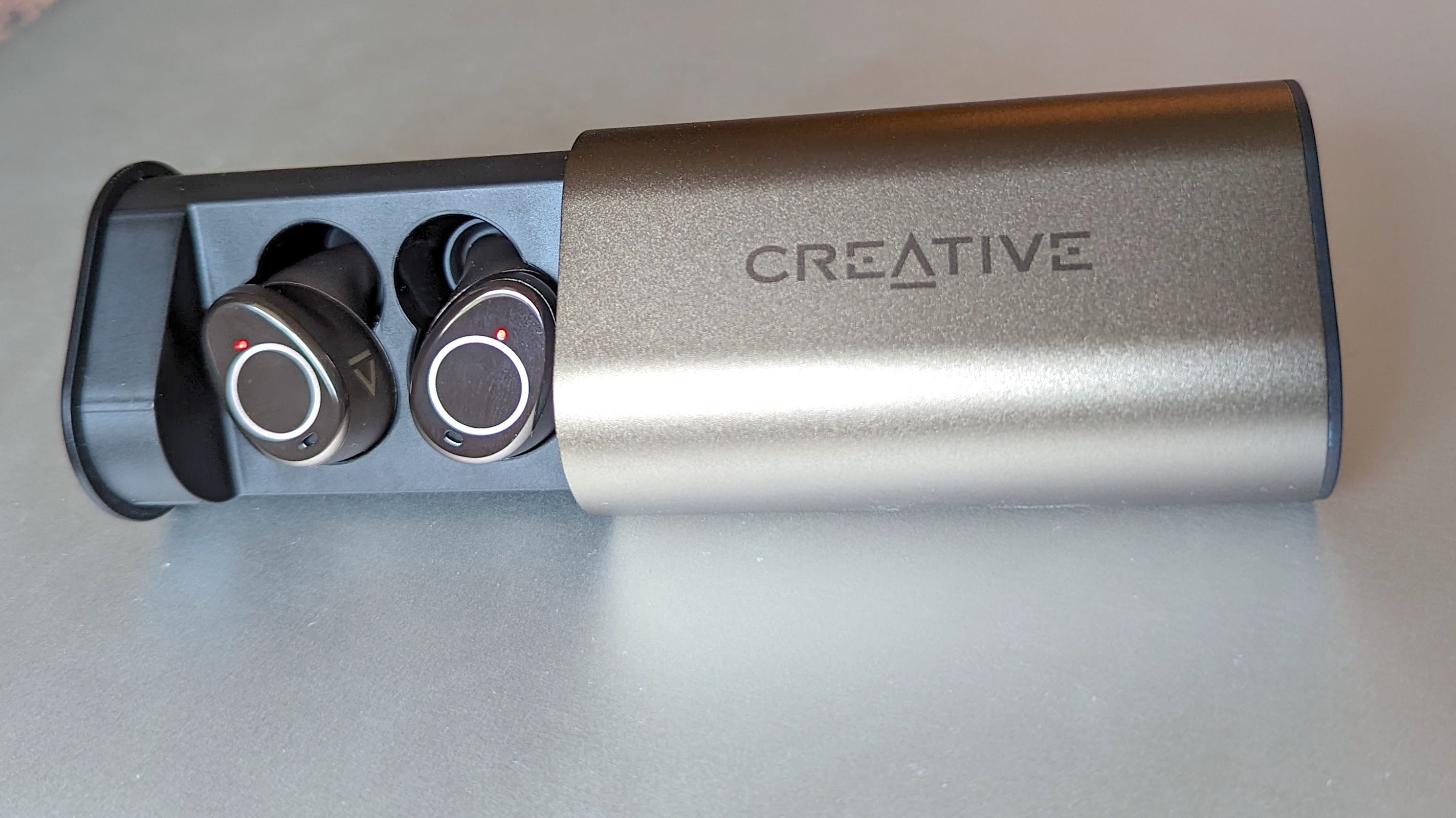 The Creative Outlier Pro ANC wireless earbuds in their charging case