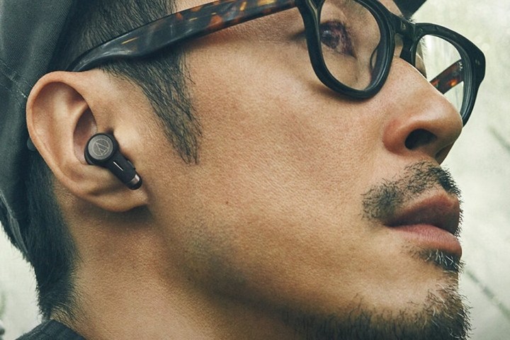 Man wearing Audio-Technica ATH-TWX9 earbuds.