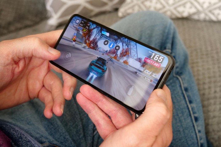 A person holding the Asus Zenfone 10 playing a game.