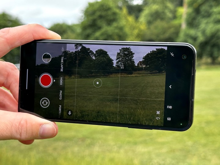 A person holding the Asus Zenfone 10 showing the viewfinder screen.