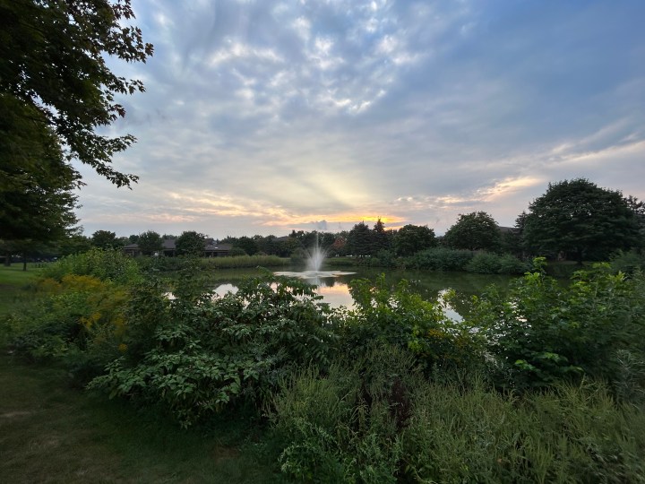 An outdoor photo of the sky and a pond, taken with the iPhone 14.