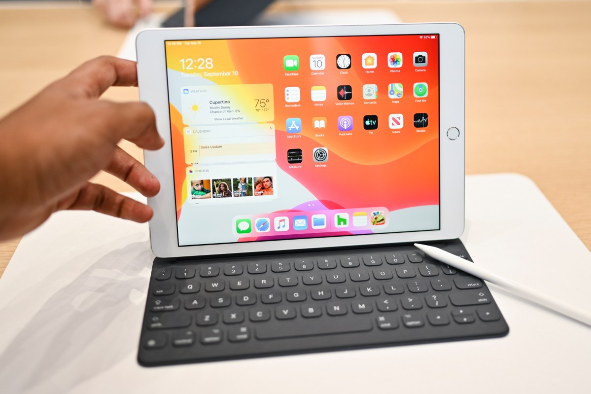 iPad 7th generation hands-on sitting on table with pencil on keyboard