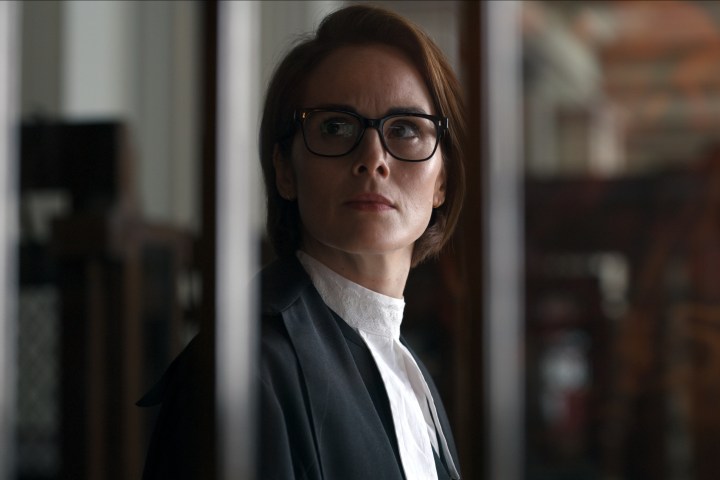 Michelle Dockery stands behind bars wearing a Barrister gown in Anatomy of a Scandal.