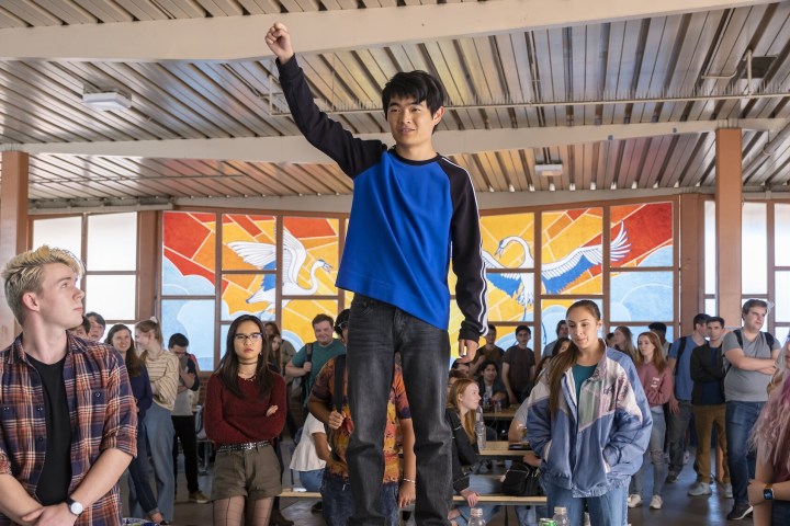 Ben Wang stands on a cafeteria table in American Born Chinese.