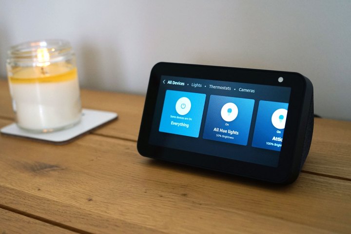 Amazon Echo Show 5 placed on top off wooden table.