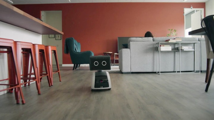 Amazon Astro Robot rolling through a living room.