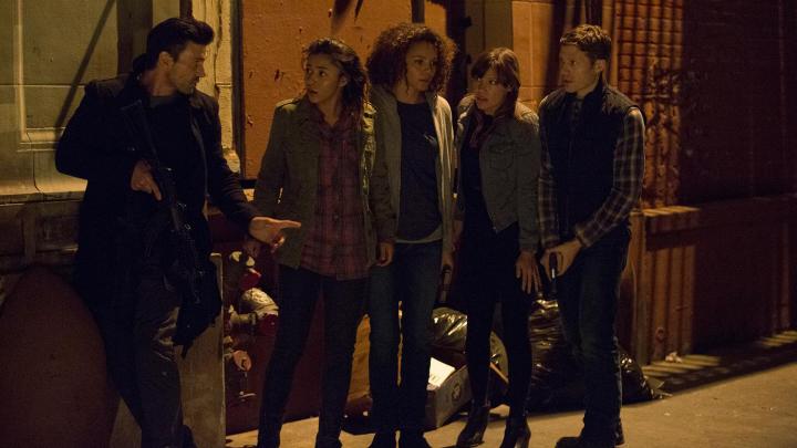 A group of individuals stand together for The Purge: Anarchy.