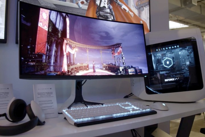 The Alienware 34 QD-OLED gaming monitor next to an Alienware PC.