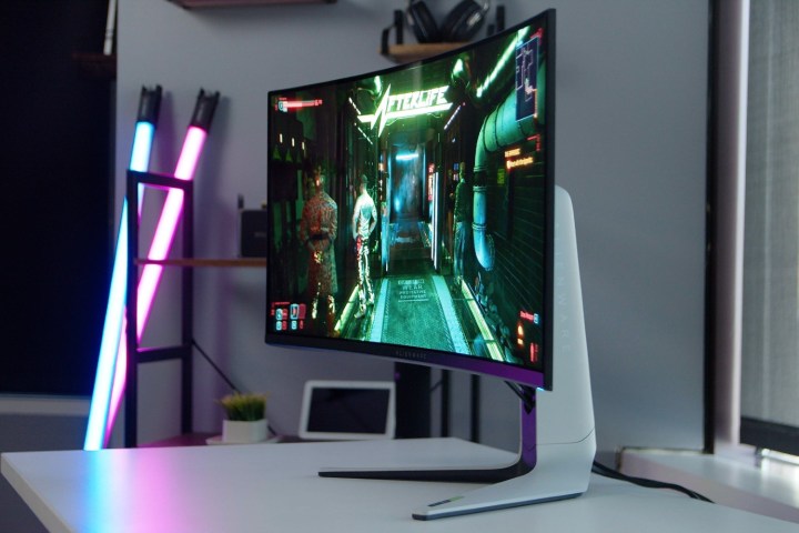 The curve of the Alienware monitor with Cyberpunk 2077 on the screen.