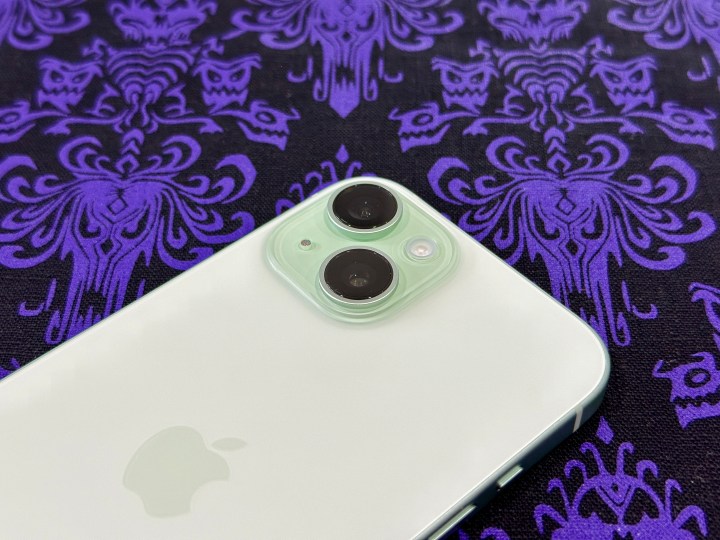 The camera module on a green iPhone 15.