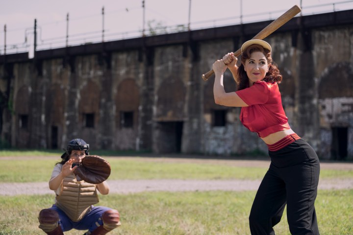 D'Arcy Carden holds a baseball bat in Amazon's A League of Their Own.