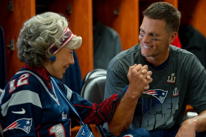 Lily Tomlin and Tom Brady clasp hands in 80 for Brady.