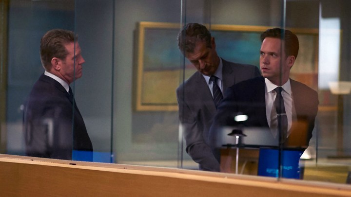 Mike being taken away in handcuffs in a scene from Suits.