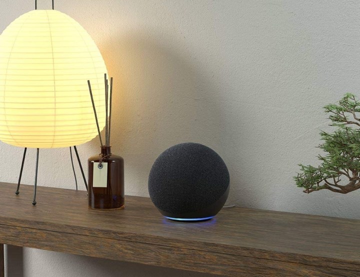 Amazon Echo 4th Gen smart speaker on a wooden table.
