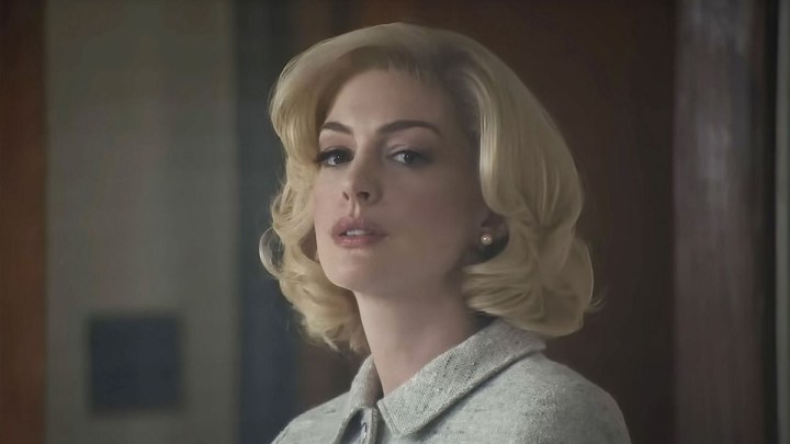 Anne Hathaway as Rebecca looking intently off-camera in Eileen.