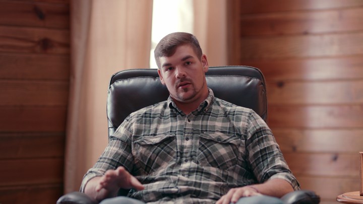 Anthony Cook sitting down in a chair talking in a scene from Murdaugh Murders on Netflix.