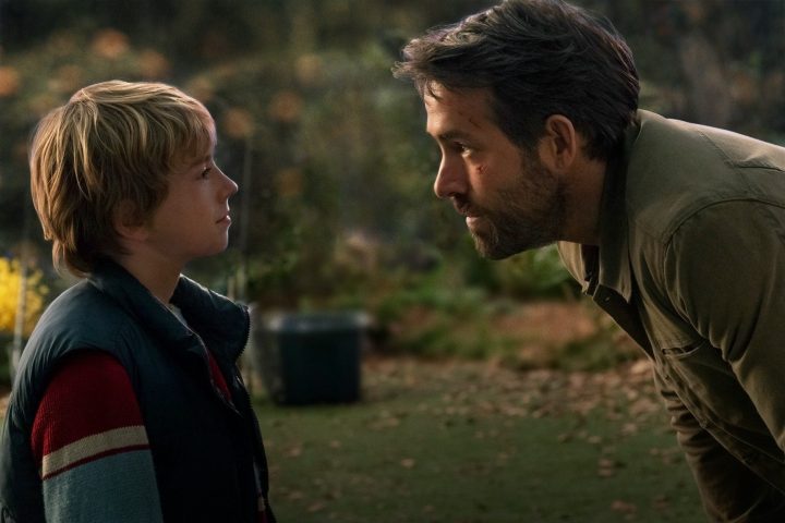 Walker Scobell and Ryan Reynolds look at each other in a scene from The Adam Project.