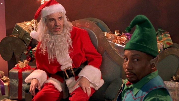 Two men dressed as Santa and an elf look in the same direction in Bad Santa.