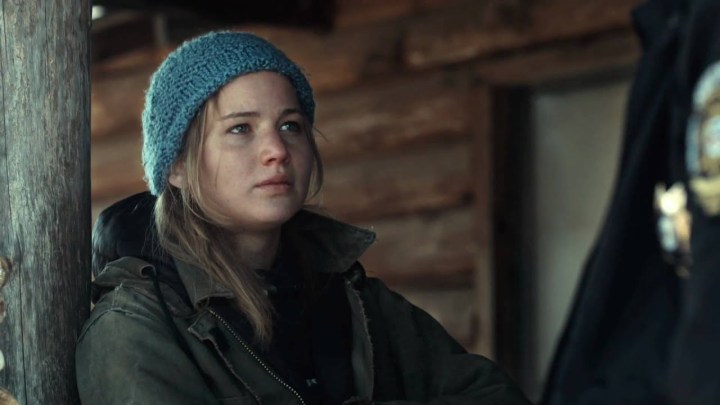 Jennifer Lawrence as Ree Dolly leaning against a wooden pillar in Winter's Bone.