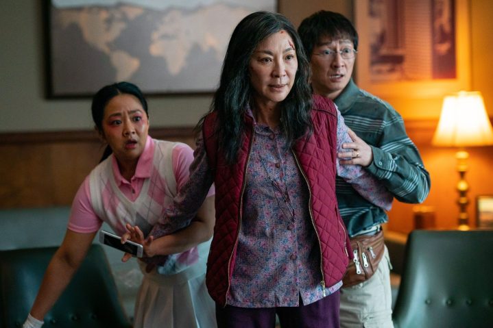 Michelle Yeoh stands in front of her character's husband and daughter in a scene from Everything Everywhere All At Once.