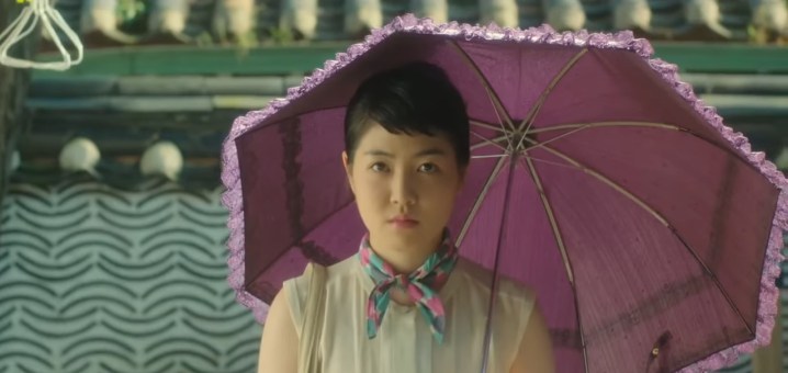 A woman holding a purple umbrella in "Miss Granny."