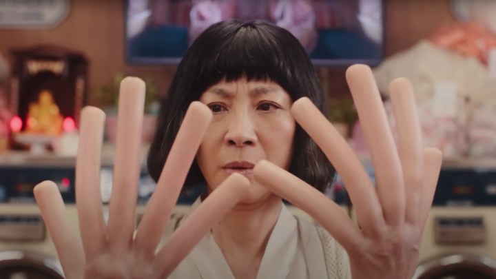 Michelle Yeoh looks at her hot dog fingers in "Everything Everywhere All at Once."