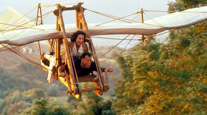 A man and a woman fly in the air in Hudson Hawk.