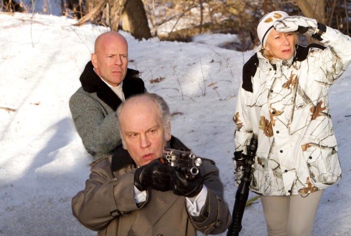 Three people hold guns in the snow in Red.