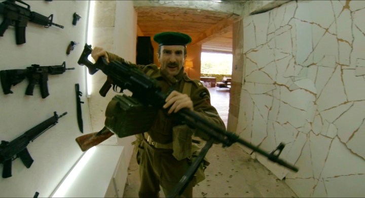 First person view of Sharlto Copley handing Henry a gun in Hardcore Henry.