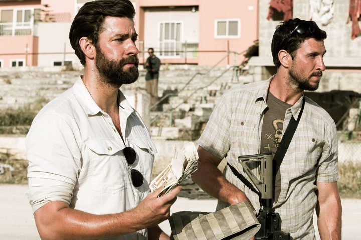 Two men hold guns next to each other in 13 Hours.