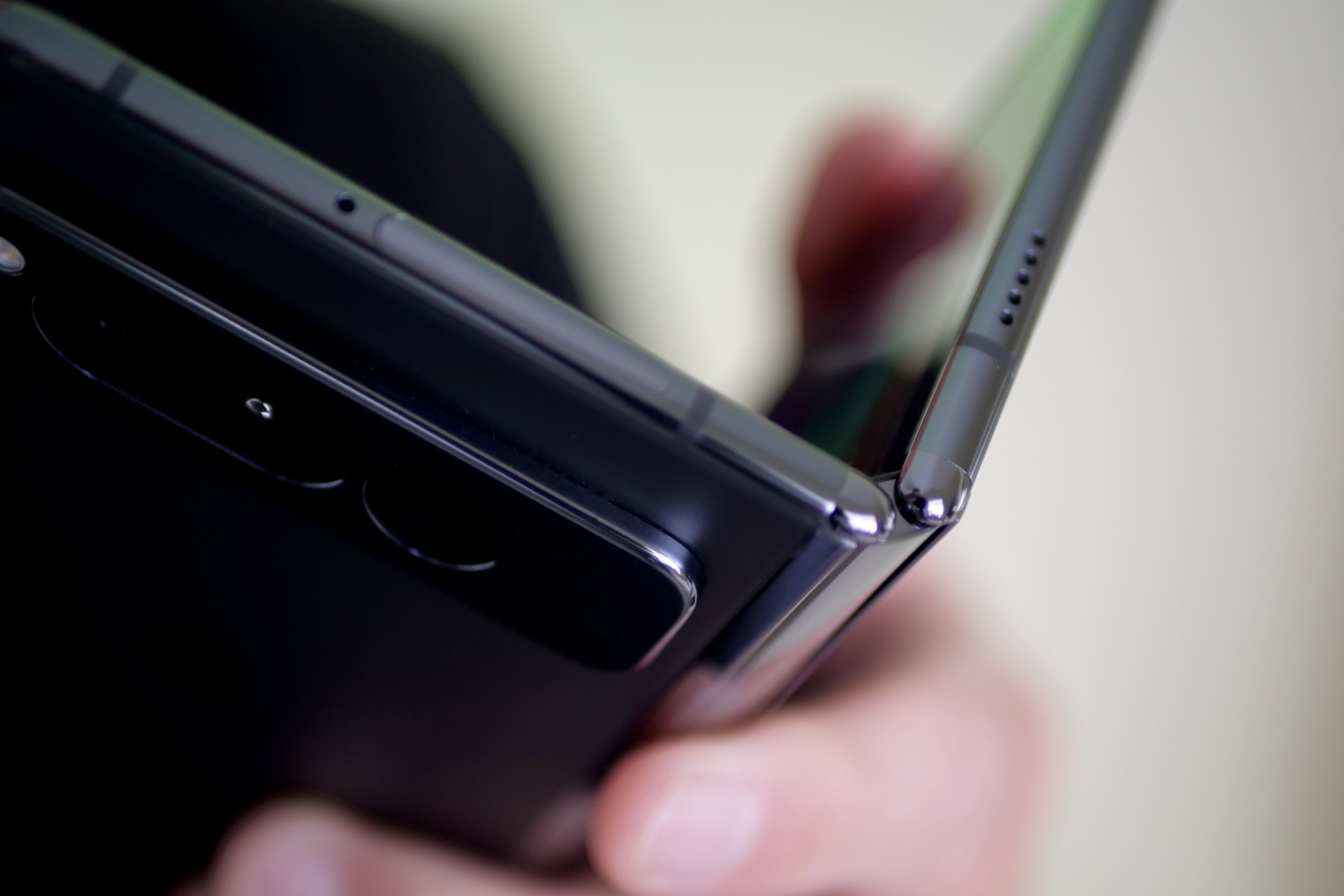 A person holding the Google Pixel Fold showing the hinge.