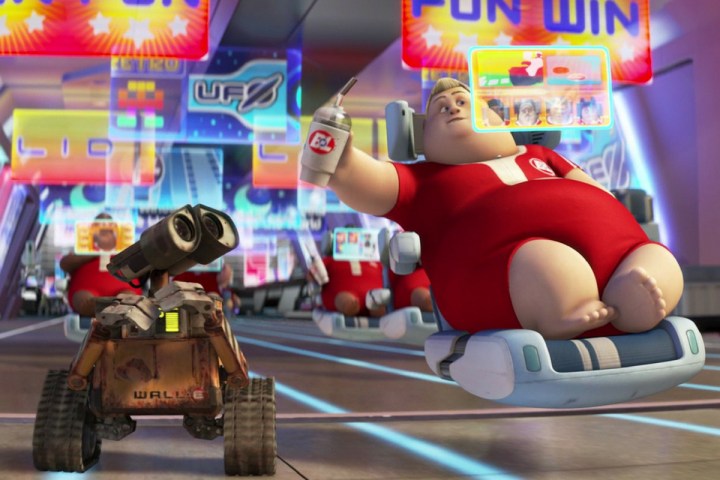 WALL-E rides next to a human in a hover chair.