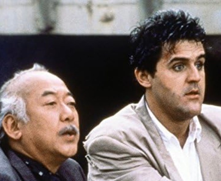 Pat Morita and Jay Leno stare with confused looks on their faces in Collision Course.