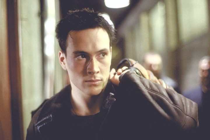 Chris Klein holds a jacket over his shoulder in Rollerball.