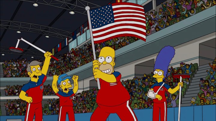 Homer waving the American flag at the Olympics with Marge, Skinner, and Agnes in "The Simpsons."