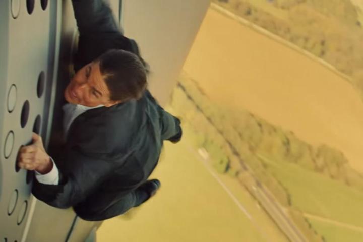 Tom Cruise hanging onto the side of a plane in "Mission: Impossible -Rogue Nation."