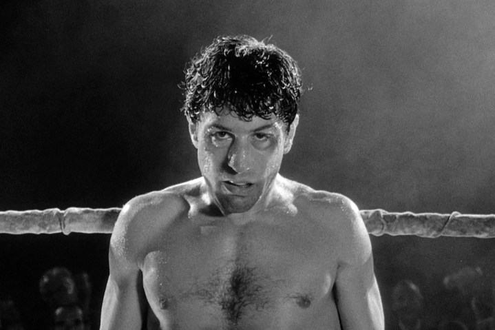 Robert De Niro stands near a boxing ring rope in Raging Bull.