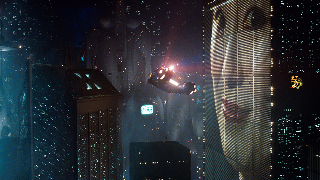 A still from Blade Runner of the skyscrapers with the big, holographic ads on them