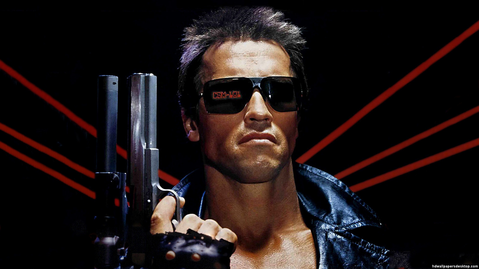 Arnold Schwarzenegger holding a gun with sunglasses on in a still from The Terminator