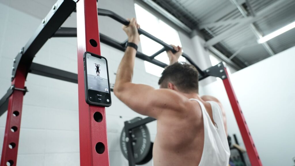 Nathan doing pull-ups and following along with Future app