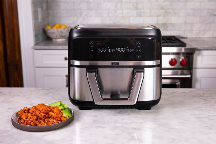 Fresh hot wings set next to the Bella Pro Series 9-quart digital air fryer.