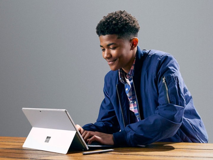 Student using Microsoft Surface Pro 7 on a table with a Type Cover.