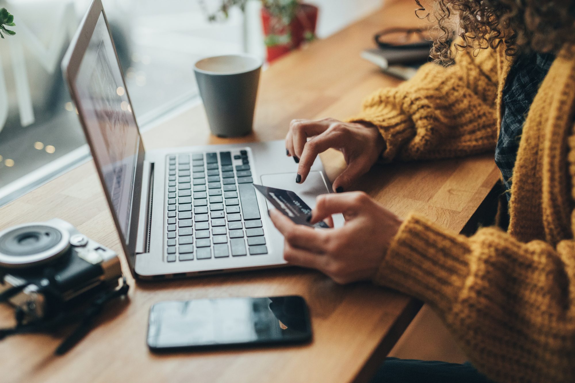 Woman entering credit card details on a laptop