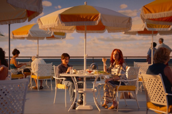 Young Beau and his mother sit on the deck of a boat together in Beau is Afraid.