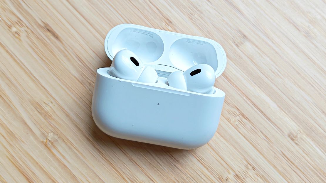 AirPods Pro (2nd Gen) encased on a wooden surface.